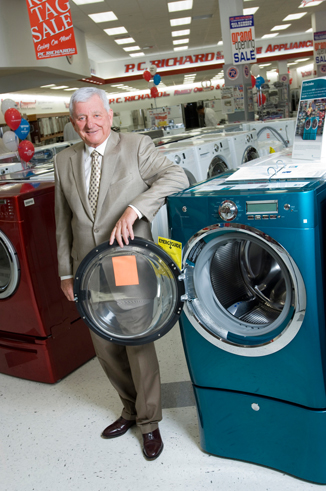 Gary Richard of PC Richard standing by washing machines in one of his stores
