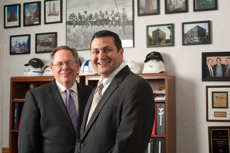 two men in business suits in office